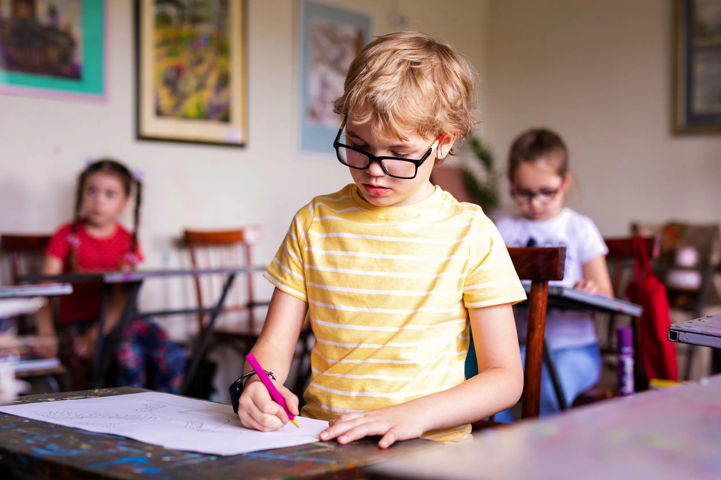 Twice exceptional student with glasses in a classroom.