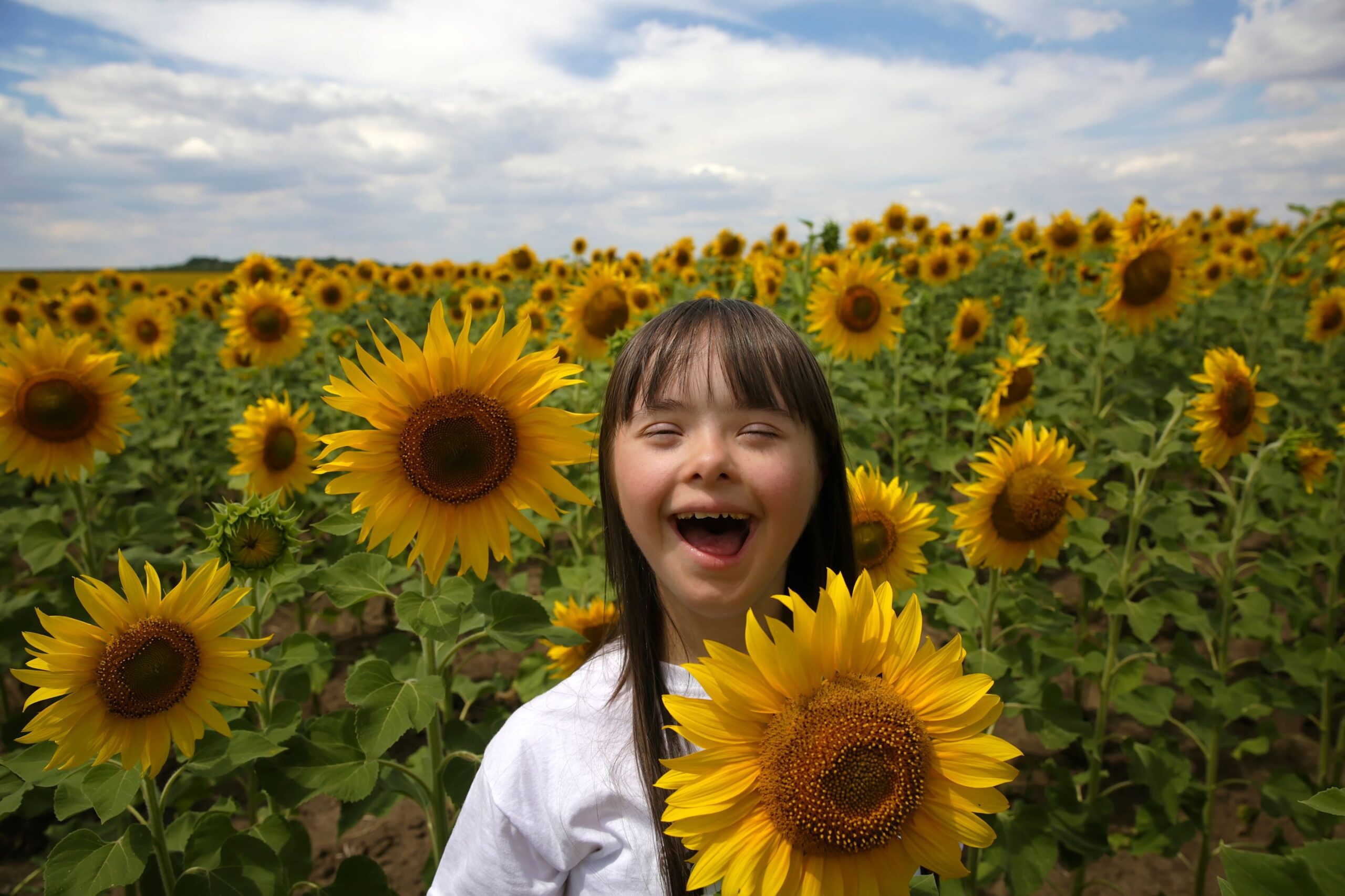 girl holding sunflowers