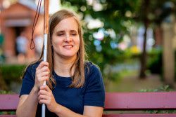 A blind woman holding a cane