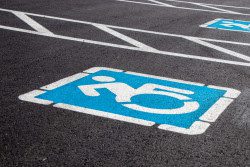 A parking lot space with a disabled parking symbol.