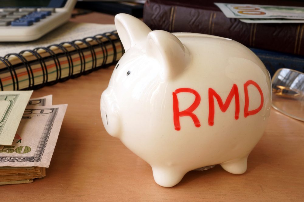 A piggy bank that says RMD; the secure act