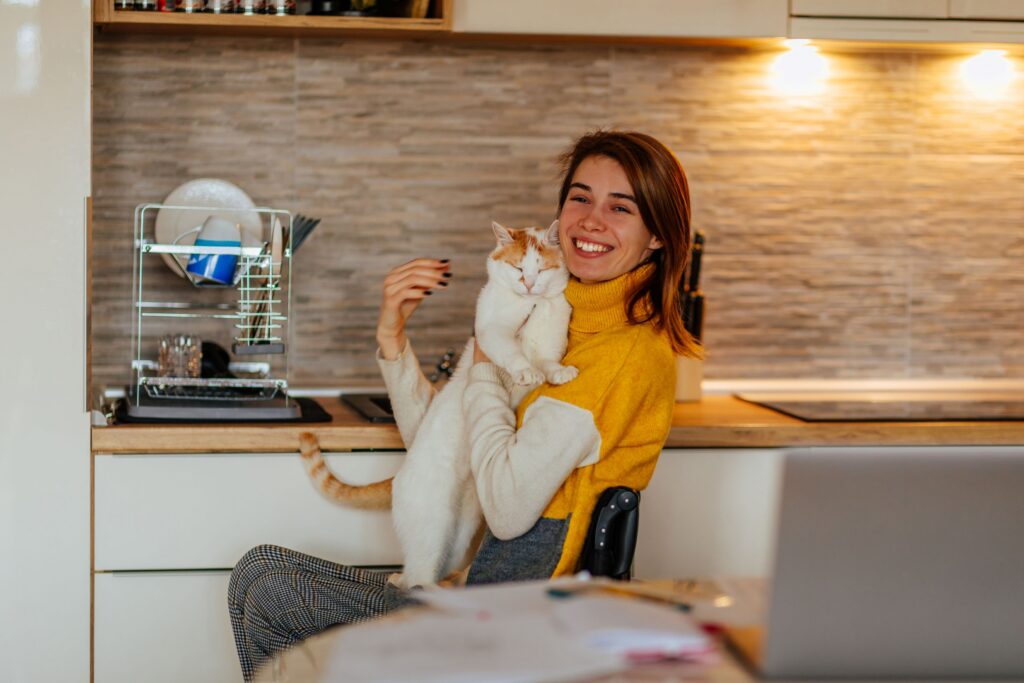 A woman hugging her cat.